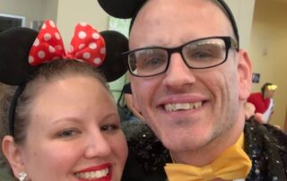 A smiling couple dressed in Mickey and Minnie Mouse costumes at a Christopher Smith Foundation event, highlighting caregiver recognition and support for caregivers of people with disabilities, fostering a sense of community and joy.| A Non Profit For Caregivers | Christopher Smith Foundation