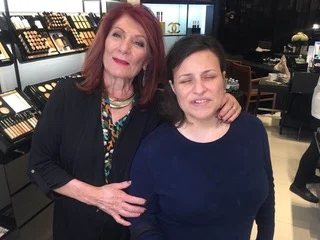 Two women stand in a makeup store; the older woman embraces the younger, both smiling. This scene highlights caregiver support and community, reflecting the Christopher…| A Non Profit For Caregivers | Christopher Smith Foundation