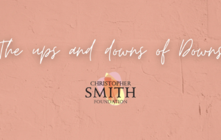 Text on a pink textured background reads "The ups and downs of Downs," with the Christopher Smith Foundation logo below, highlighting their focus on caregiver support.| A Non Profit For Caregivers | Christopher Smith Foundation