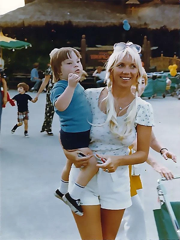 A smiling woman holds a child with a disability in an outdoor setting, illustrating caregiver support. The image reflects the Christopher Smith Foundation’s mission to honor caregivers of people with disabilities.| A Non Profit For Caregivers | Christopher Smith Foundation