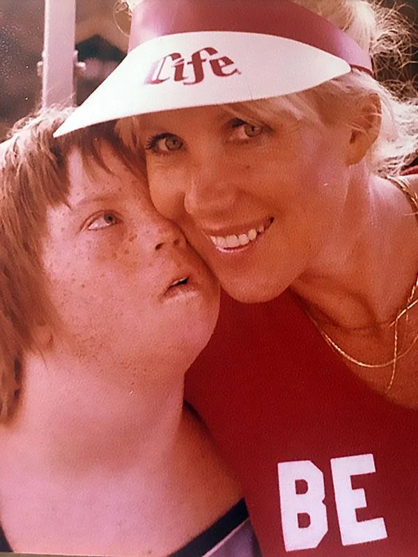 A caregiver smiles warmly with a child, embodying the Christopher Smith Foundation's mission of caregiver support and disability advocacy, highlighting the bond between caregivers and individuals with disabilities.| A Non Profit For Caregivers | Christopher Smith Foundation