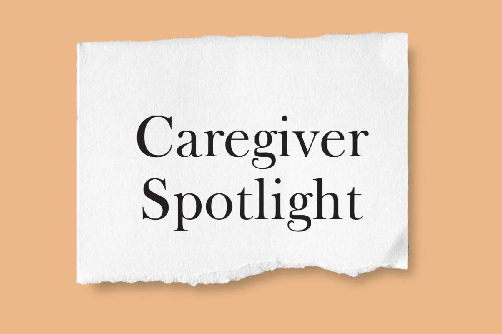 A piece of white paper with torn edges displays the text "Caregiver Spotlight" in black font, set against a light brown background, highlighting caregiver recognition by the Christopher Smith Foundation.| A Non Profit For Caregivers | Christopher Smith Foundation